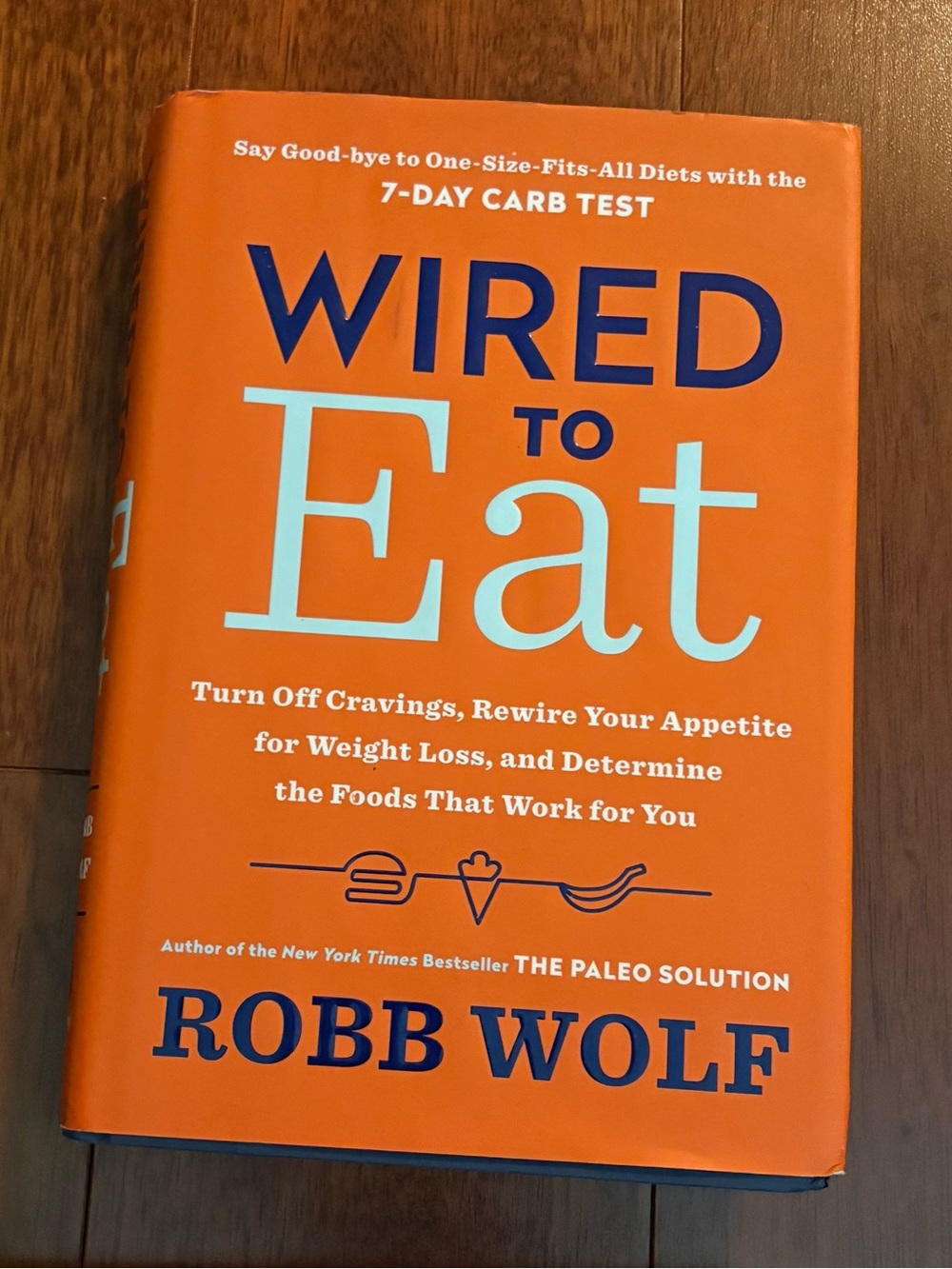 Wired to Eat by Robb Wolf - Bright Orange Hardcover Book